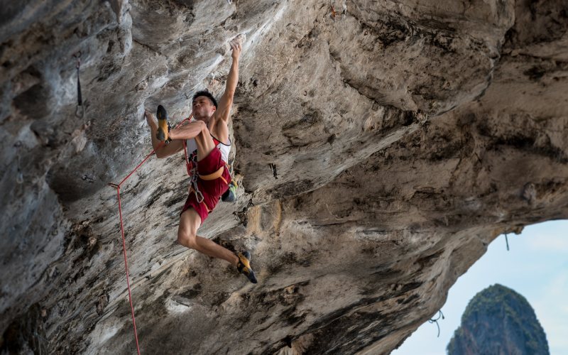 man climbing on rock